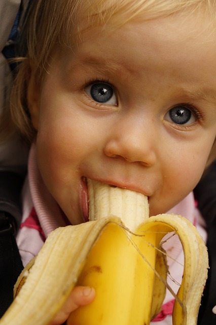 child eating banana